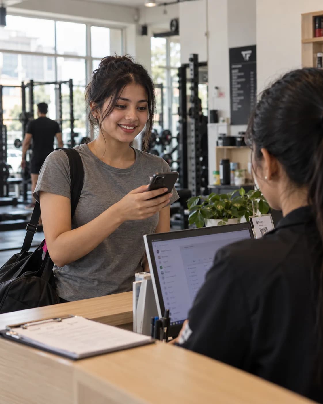 A member holds up the pass on their phone